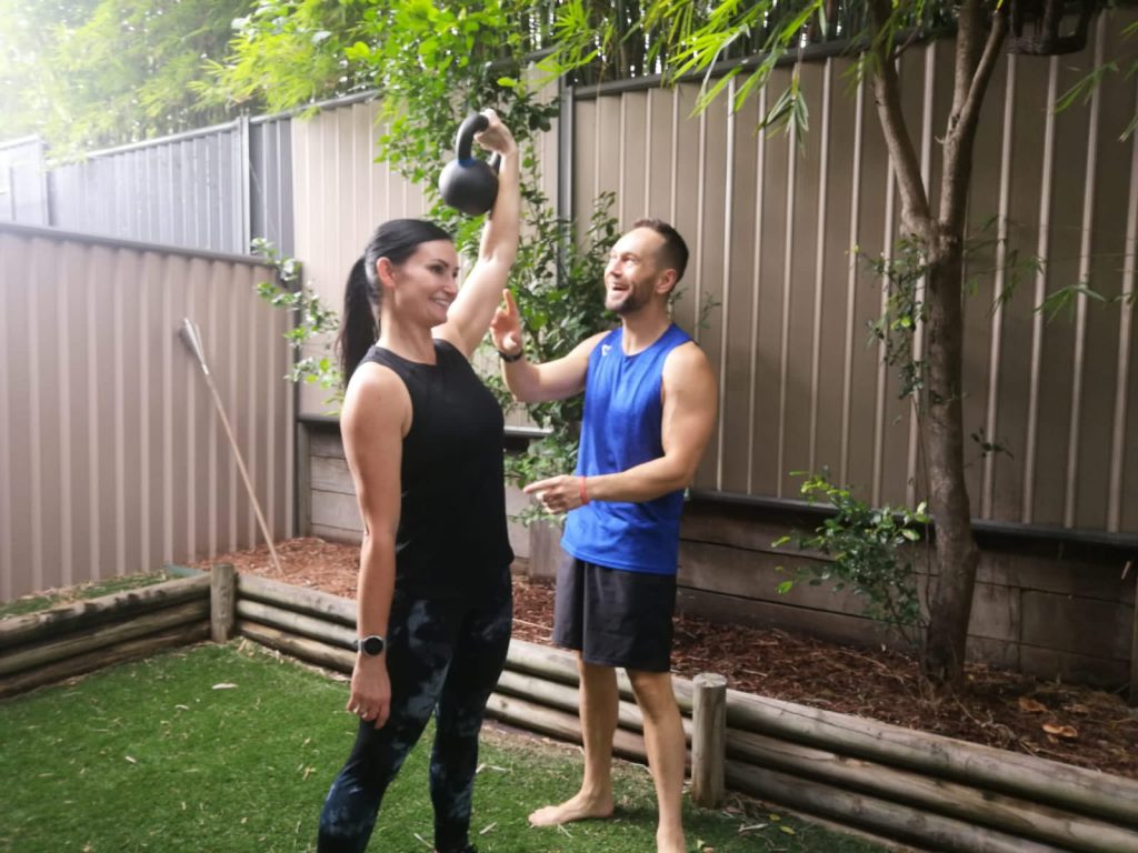 Riddlock trainer training his client, they are both smiling and having a great time.