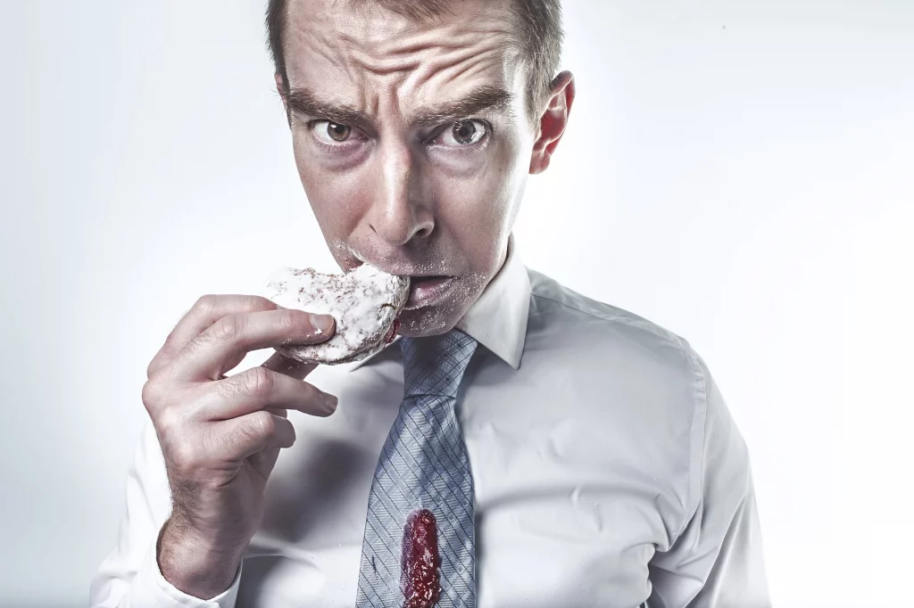 man eating a jelly doughnut